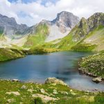 glacial lake beneath steep mountain peaks